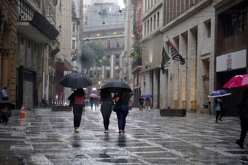 Pedestres se protegem da chuva na região central de São Paulo