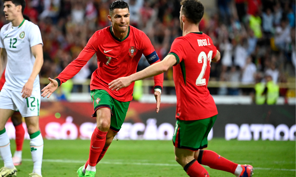 O atacante português nº 07, Cristiano Ronaldo, comemora seu segundo gol com o atacante português nº 21, Diogo Jota, durante o amistoso internacional entre Portugal e Irlanda, no Estádio Municipal de Aveiro, em 11 de junho de 2024, antes do torneio de futebol UEFA Euro 2024, na Alemanha. (Foto de MIGUEL RIOPA / AFP)