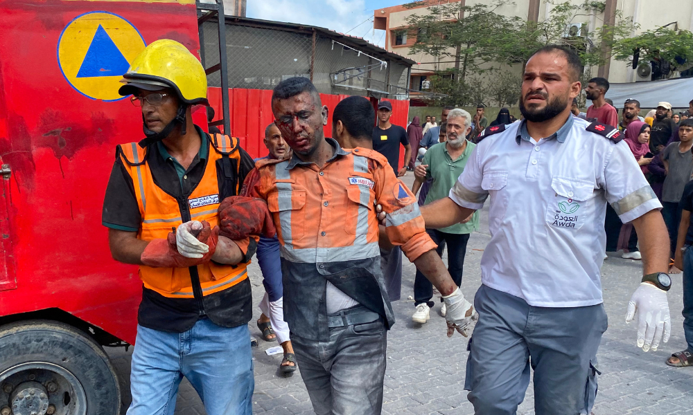 Conteúdo gráfico / Médicos palestinos transportam um homem ferido para o Hospital Nasser em Khan Yunis, no sul da Faixa de Gaza, em 25 de agosto de 2025, após ataques israelenses. A agência de defesa civil de Gaza informou que os ataques israelenses ao hospital mataram pelo menos 15 pessoas em 25 de agosto, incluindo quatro jornalistas e um membro da defesa civil. (Foto: AFP)