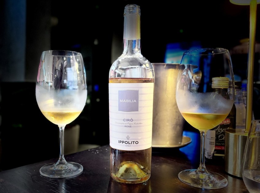 Garrafa de vinho na mesa entre duas taças